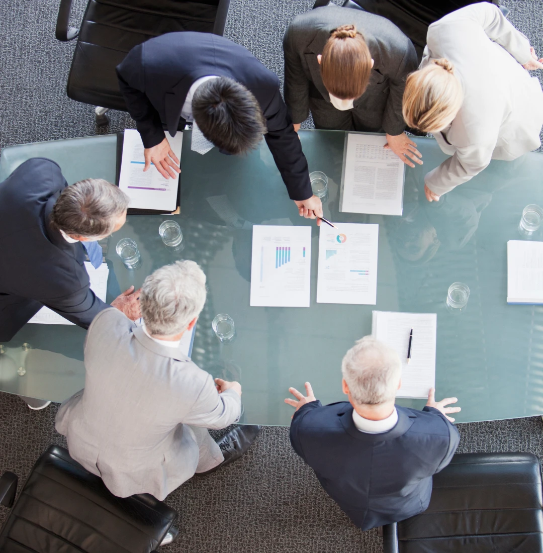 Colleagues discussing data at conference table