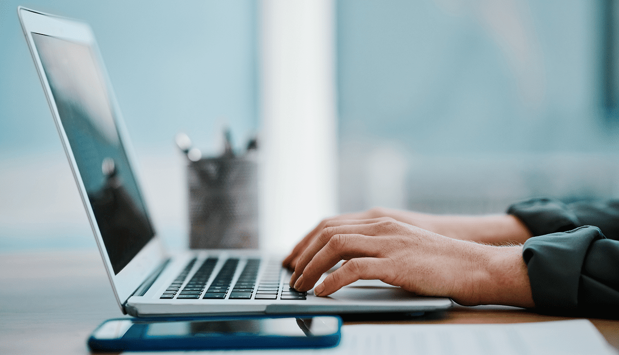 Close-up of hands using a laptop