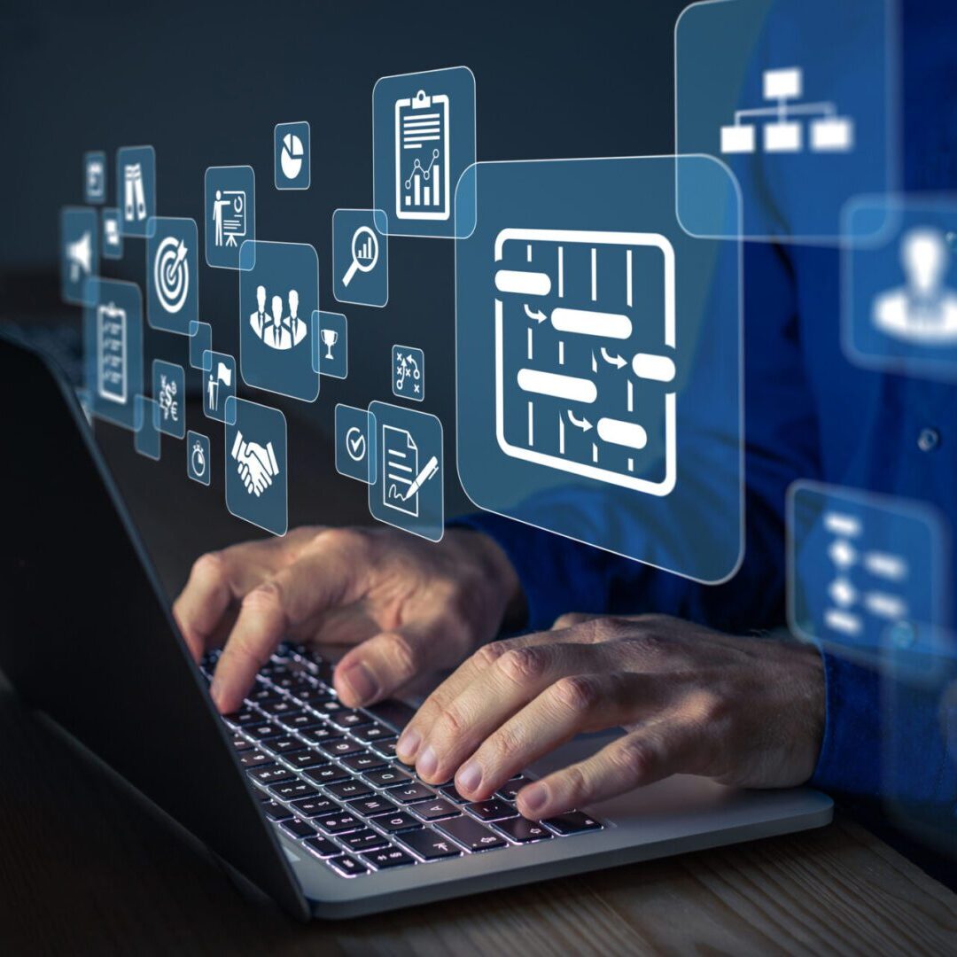 Man typing with floating technology symbols