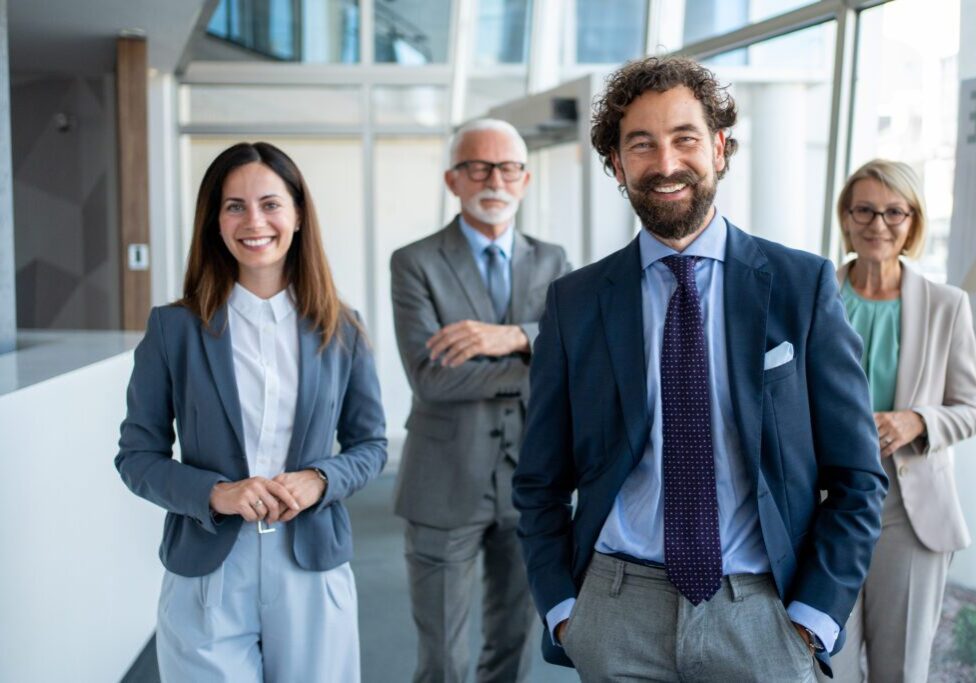 Business professionals smiling in modern office setting.